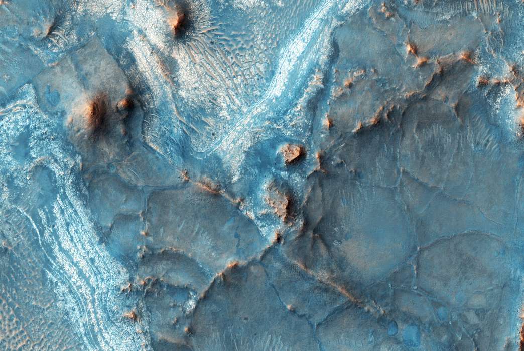 A false-color image of Nili Vossae, a site on Mars where layers of faults and troughs contain rare evidence of ancient water on the red planet. (NASA/JPL/University of Arizona)